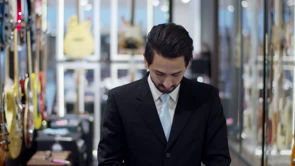Portrait video young smart businessman at modern musical instrument store
