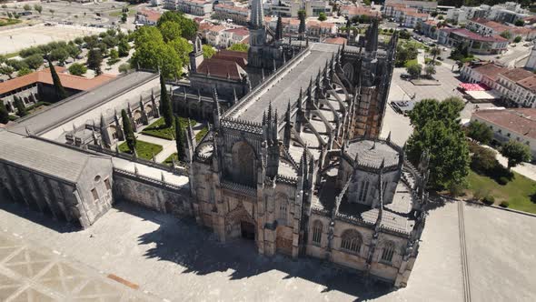 Masterpiece building with towers of Batalha Monastery in Portugal, aerial orbit view alt