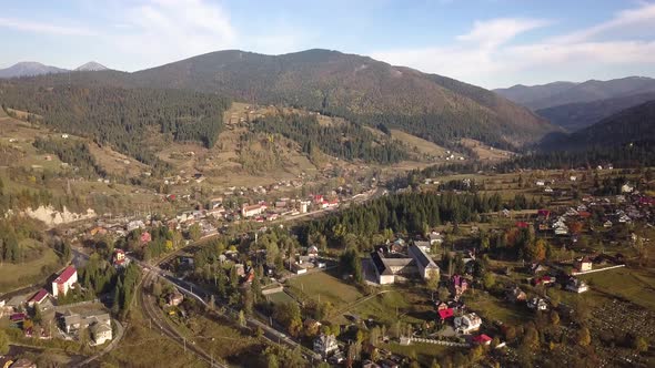 Aerial view of autumn mountain landscape with evergreen pine trees and yellow fall forest with alt