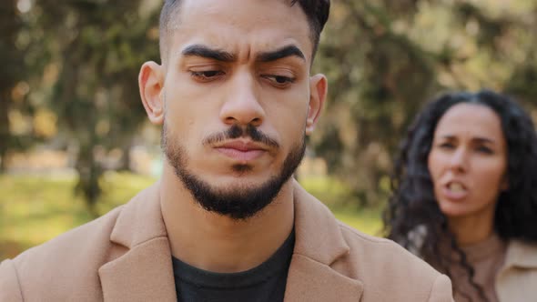 Emotional Quarrel of Hispanic Couple Outdoors Angry Girlfriend in Background Yelling and Scolding alt