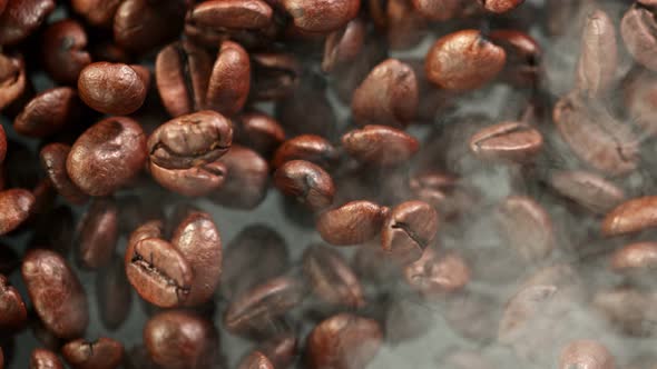 Super Slow Motion Detail Shot of Coffee Beans and Smoke Background at 1000Fps alt