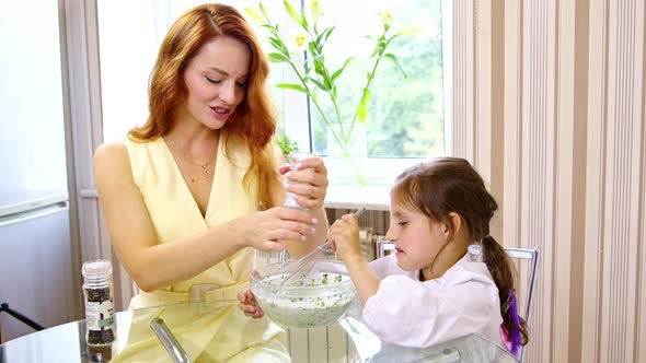 Mom and Daughter Cook Together Stirring Sauce Adding Pepper and Spinach