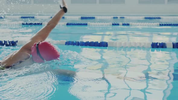 Skillful Female Swimmer Trains in the Pool alt