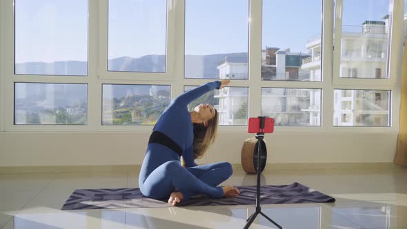 Slim Woman in Tracksuit Does Yoga Exercise Shooting Blog