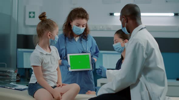 Tripod Shot of Assistant Holding Tablet with Horizontal Green Screen alt