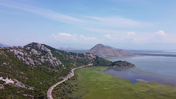 Bird's Eye View of Mountainous Terrain with Mountain Road at the Foot