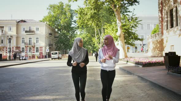 Two Muslim Women in Sportswear and Colorful Hijabs alt
