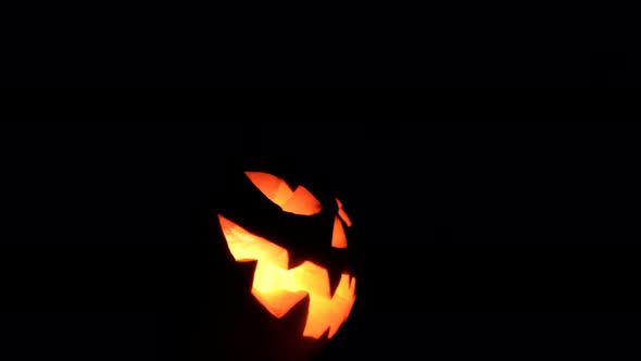 Halloween Pumpkin Turns a Scary Face Into the Camera.