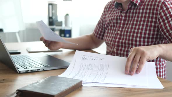 Freelancer Doing Paperwork in Modern Office Space