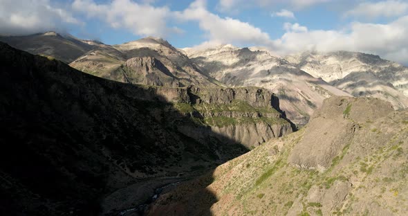 Aerial view of the arid mountains of the central zone in the maule region of chile on a sunny day. alt