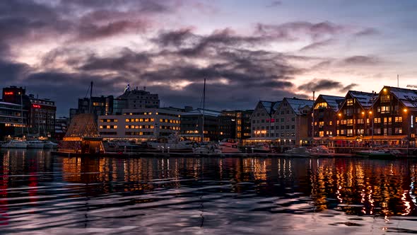 Illuminated buildings of Tromso Harbour at twilight, Norway, time lapse alt