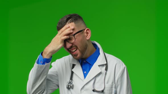 Exhausted Young Doctor in Coat Has Headache From Fatigue and Overexertion From Working in Heavy alt