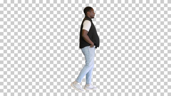 Attractive black man walking with hand in his pocket, Alpha Channel alt
