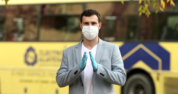 Businessman wearing face mask and greeting with namaste. alt