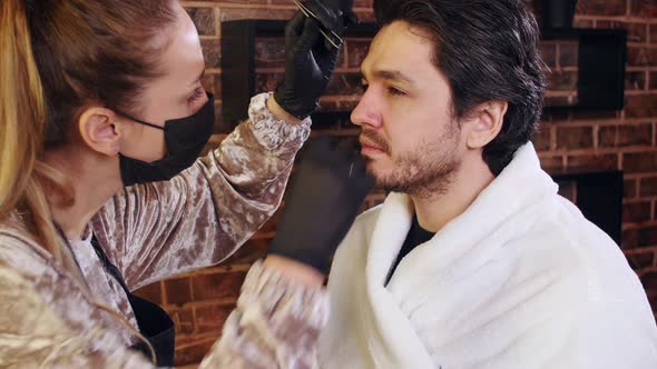 Young Stylish Man in a Beauty Salon. Face and Eyebrow Care