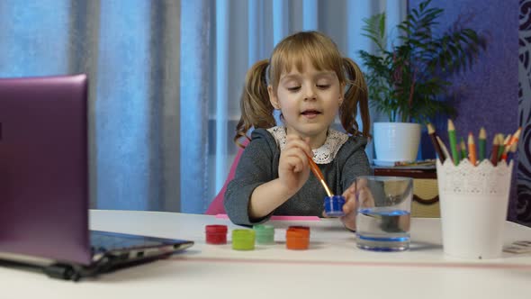 Child Girl Schoolgirl Enthusiastically Drawing with Brushes and Paints Distance Education at Home alt
