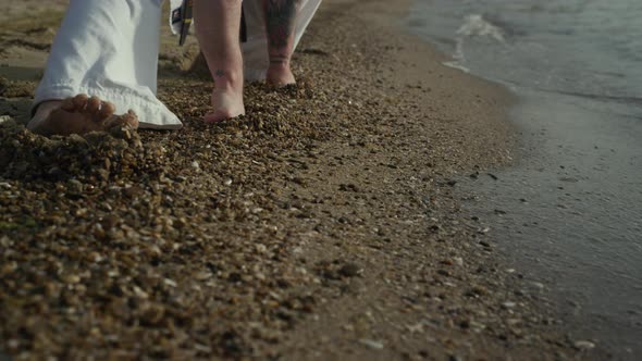 Closeup Man Legs Stretching on Wet Sand alt