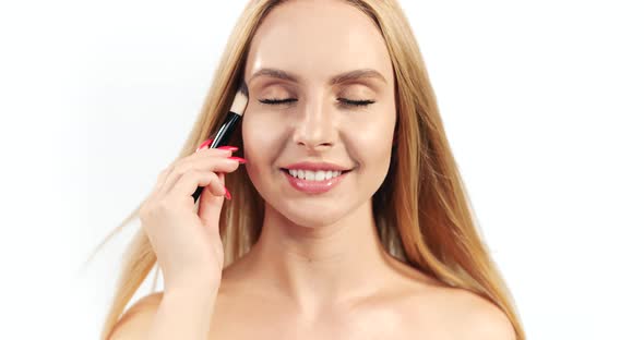 Blonde Woman with Makeup Brush Closeup