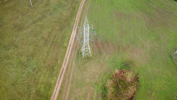 Electricity Pylon Tower With Wires Lines On Field In Country Area