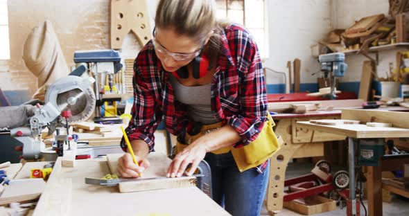 Portrait of attractive carpenter drawing and smiling for camera alt