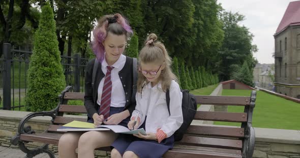Two Schoolgirls Sitting on Bench, Primary and High School Student alt