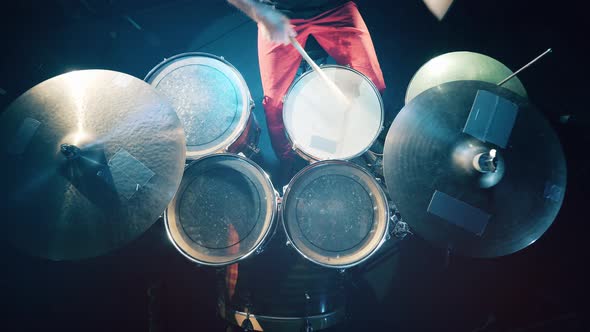 Top View of the Sticks in Drummer's Hands Hitting the Drums alt