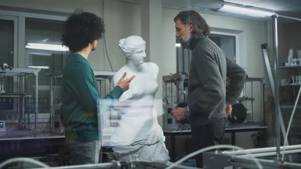 Male Designers Discussing Plastic Sculpture Near 3D Printers alt