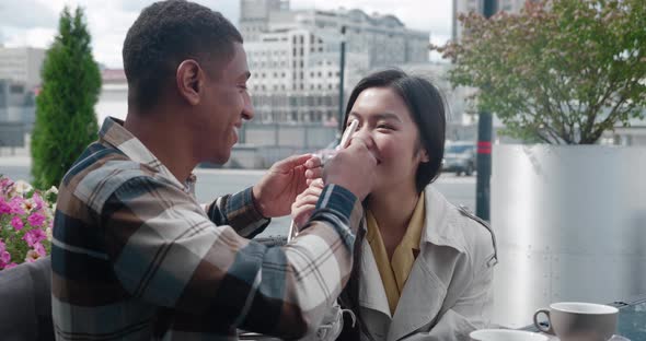 Rear View of a Man Covering His Eyes with Hands Then Rejoices Looking at His Girlfriend Positive alt