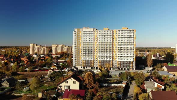 High-rise Residential Building Under Construction Among Private Houses in Russia