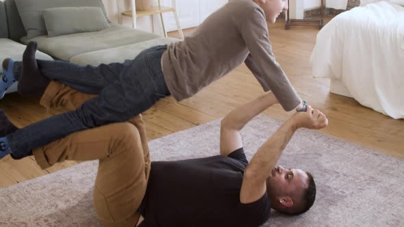 Caucasian Father Having Fun with His Son at Home