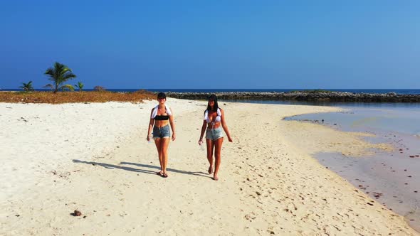 Girls posing on relaxing coastline beach holiday by shallow sea with white sandy background of Thail alt