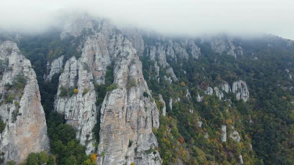Mountains with Rocky Sculptures That are Getting Covered By Clouds