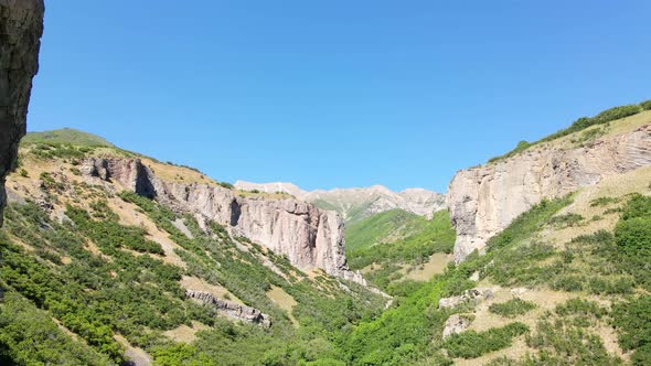 Flying backward and dangerously close to as shear cliff in a rugged canyon wilderness alt