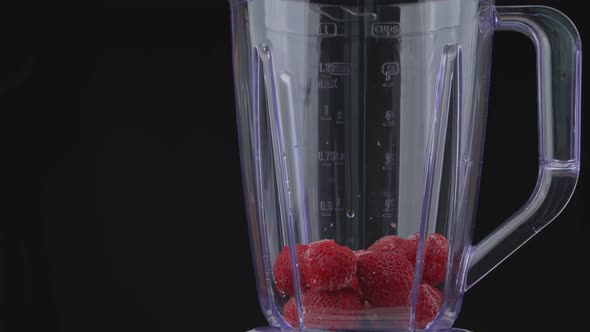 Strawberries and Currants are Poured Into the Blender Bowl alt