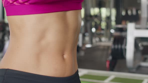 Asian healthy sport woman wearing smartwatch device check heart rate result after workout in gym. alt