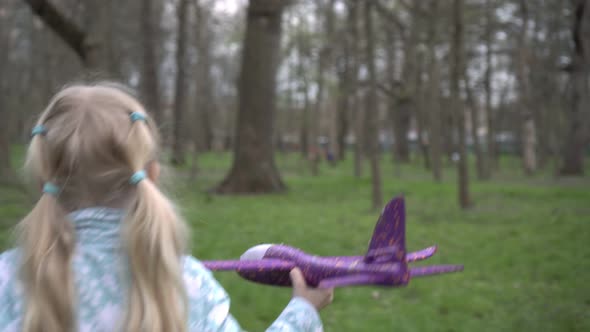 The Child Runs with a Toy Plane alt
