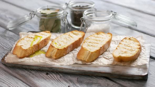Spoon Puts Vegetables on Toasts. alt