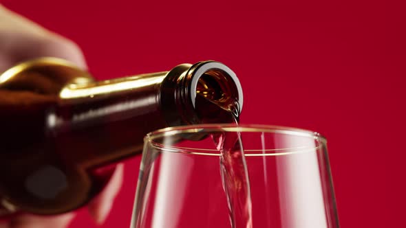 Pouring Foamy Cherry Beer in Glass Closeup Belgian Lambic alt