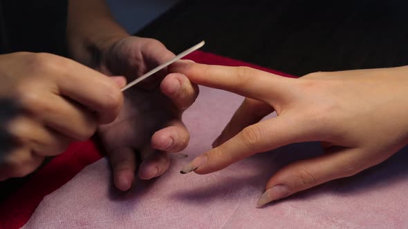 Anonymous Beautician Doing Manicure to Female Client