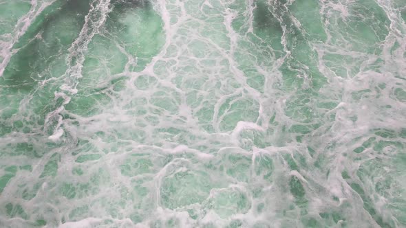 Aerial shot of a large flow of turquoise water. Nature background. Splashes and foam from the flow o