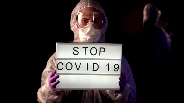 Doctor, Virologist, Scientist, Man Wearing Chemical Protection Suit, Respirator Holding Lightbox