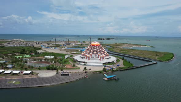 Waterfront mosque with 99 orange domes in Makassar city Sulawesi Indonesia along the ocean on a sunn alt