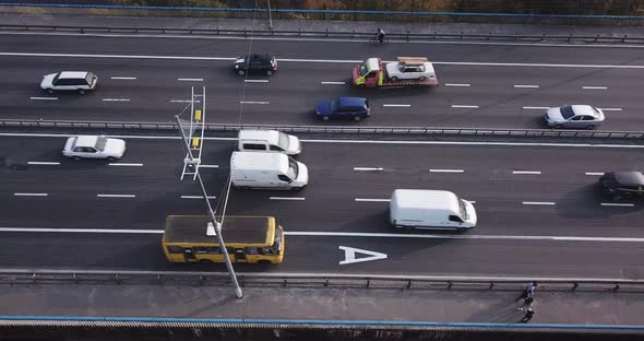 View of the Bridge Carriageway From Above at an Angle, Pedestrians and Cyclists, at Sunset.