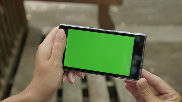 Green screen chroma key tablet in woman hands outdoor  zoom out 4K 2160p 30fps UHD video - Blond fem alt