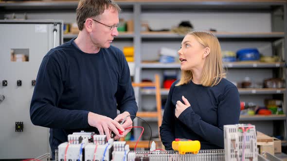 Electrician using voltmeter and checking electricity alt