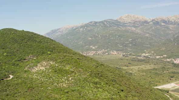 Drone Video of a Village with Houses in the Lowlands Surrounded By Forests alt