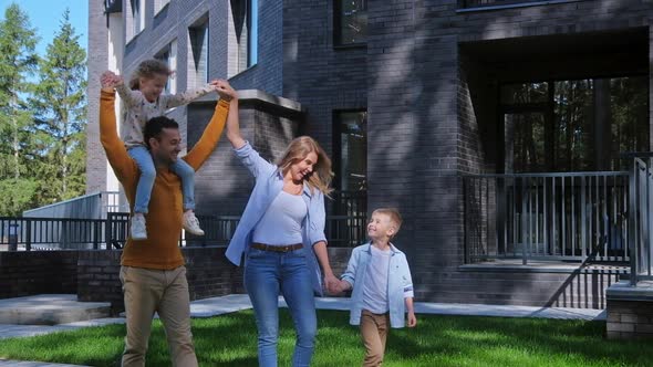 Family Walking at Summer Day at Backyard of House alt