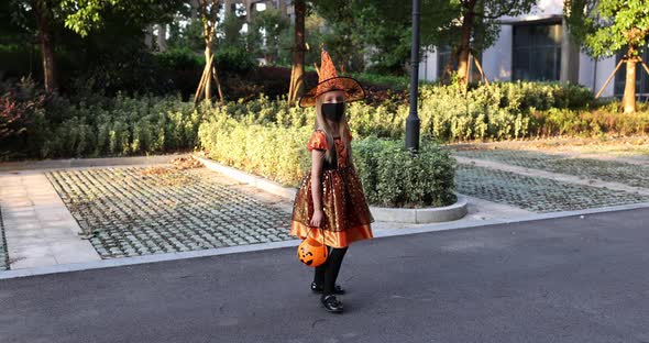Cute Little Caucasian Girl with Blonde Hair Seven Years Old in Costume of Witch with Hat and Black alt