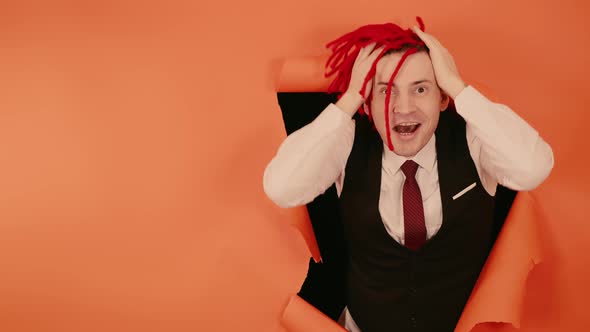 Happy Smiling Man with Red Dreadlocks in Hole in Wall alt