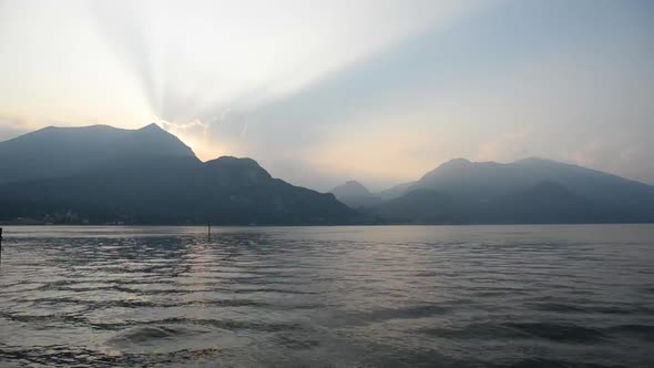 Sunset on Como lake in Italy. View from Bellagio. Landscape with Mountains. Time Lapse.